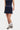 Person wearing a navy polka dot skort with a white background